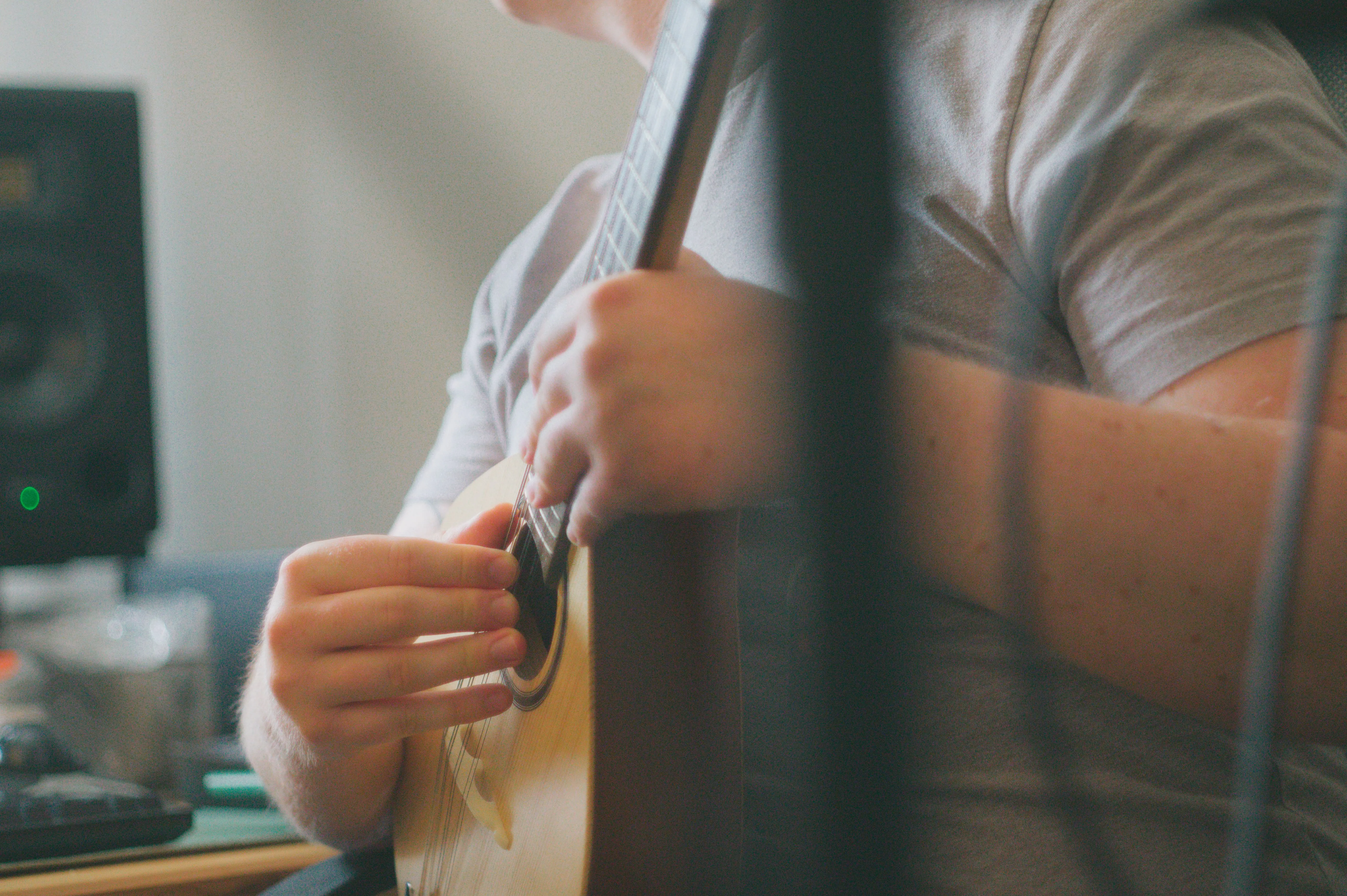 A photo of Barney Rudkins-Stow playing a mandolin.